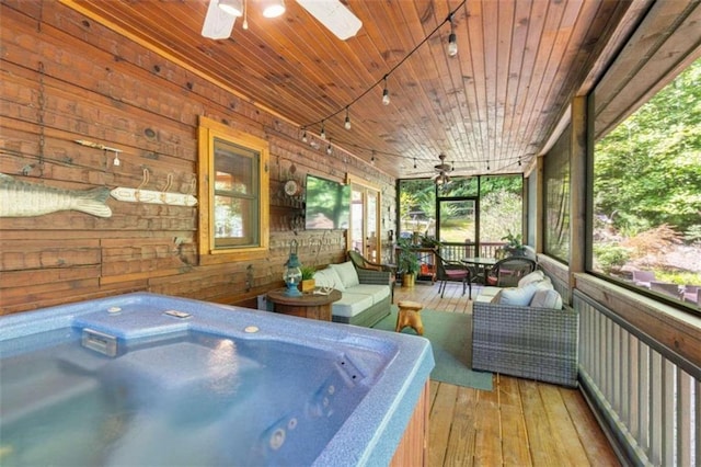 sunroom featuring a jacuzzi, ceiling fan, and wooden ceiling