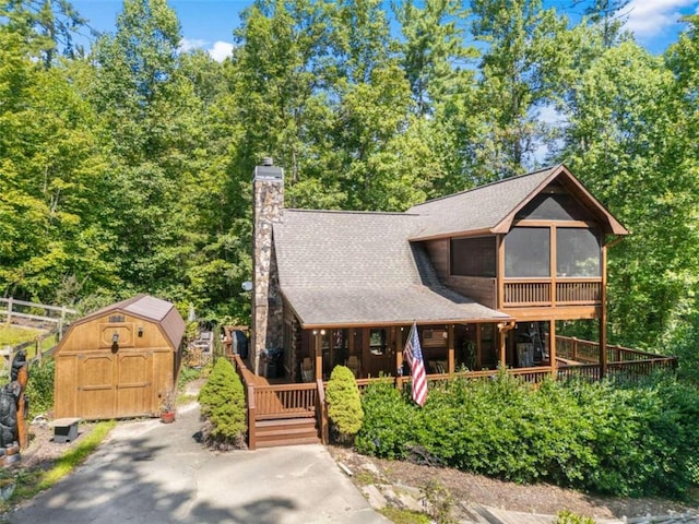 view of front of home with a shed