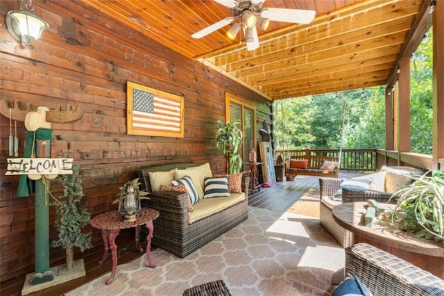 sunroom with wood ceiling, plenty of natural light, and ceiling fan