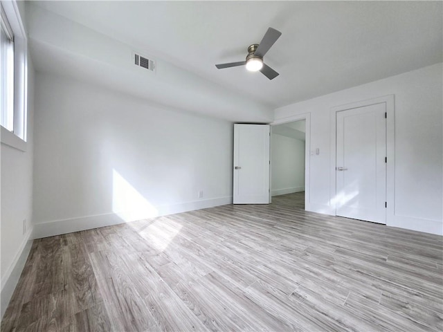 unfurnished bedroom featuring visible vents, baseboards, light wood-style flooring, and a ceiling fan