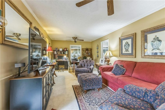 living area with carpet floors, ornamental molding, a ceiling fan, and a textured ceiling