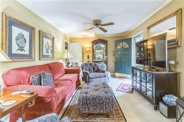 living room with a ceiling fan, carpet, and ornamental molding