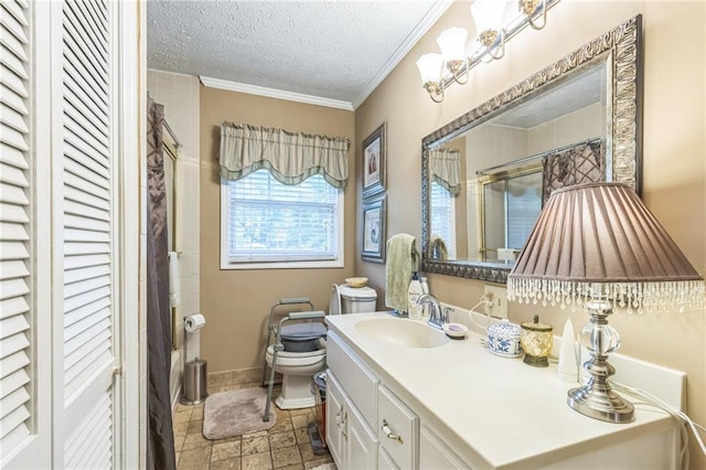 bathroom featuring vanity, toilet, a textured ceiling, baseboards, and ornamental molding