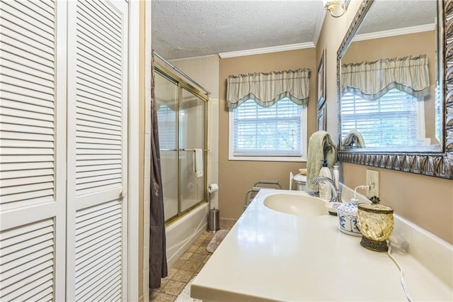 full bathroom with crown molding, shower / bath combination with glass door, vanity, a textured ceiling, and a closet