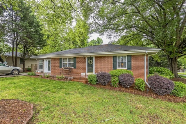 ranch-style home with brick siding and a front lawn