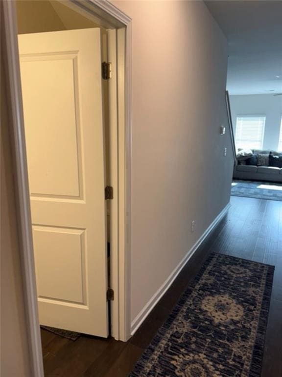 hallway with dark hardwood / wood-style floors