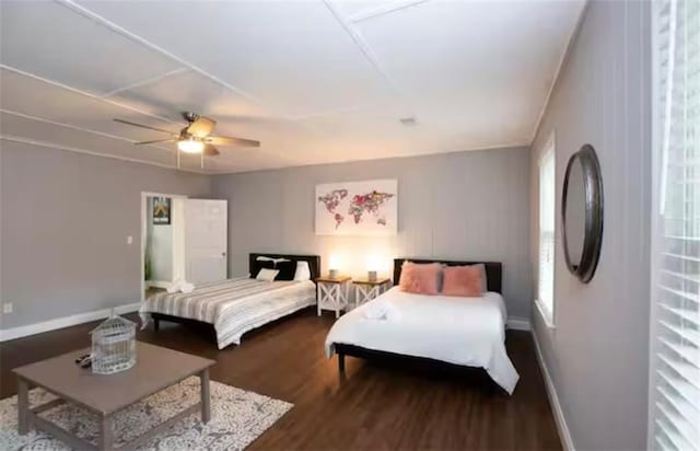 bedroom with ceiling fan, baseboards, and wood finished floors