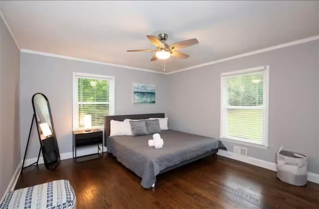 bedroom with baseboards, visible vents, wood finished floors, and ornamental molding