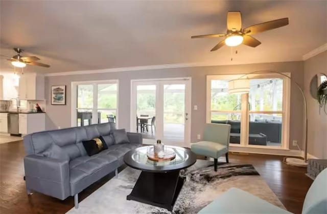 living room with ceiling fan, a healthy amount of sunlight, crown molding, and wood finished floors