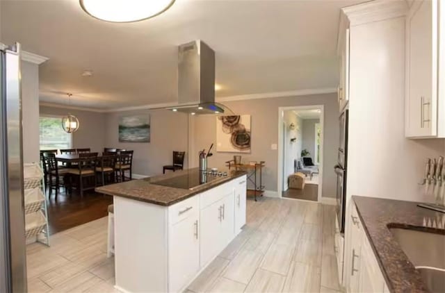 kitchen featuring crown molding, black electric stovetop, white cabinets, and island range hood