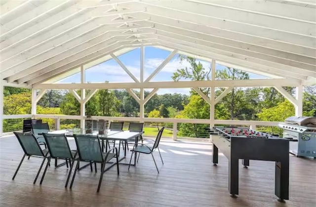 sunroom featuring vaulted ceiling and a wealth of natural light