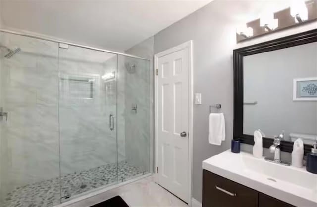 full bath with a shower stall and vanity