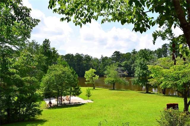 exterior space with a water view and fence