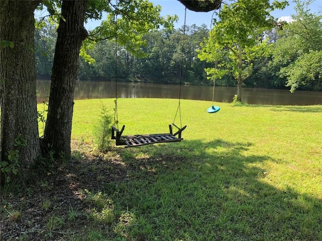 view of yard featuring a water view and a forest view