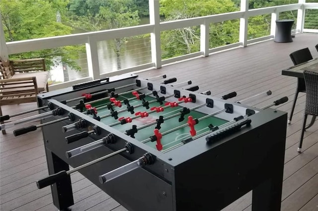 game room with a wealth of natural light and hardwood / wood-style flooring