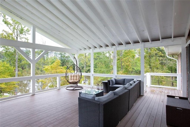 sunroom / solarium with vaulted ceiling with beams