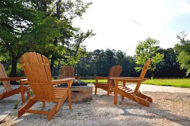 view of playground with a patio area and a fire pit