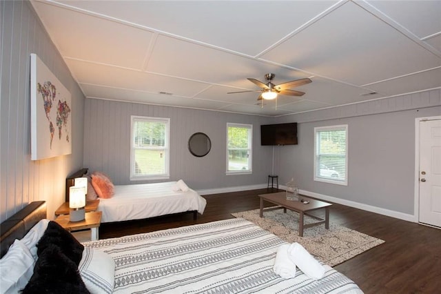 bedroom with ceiling fan, baseboards, and wood finished floors