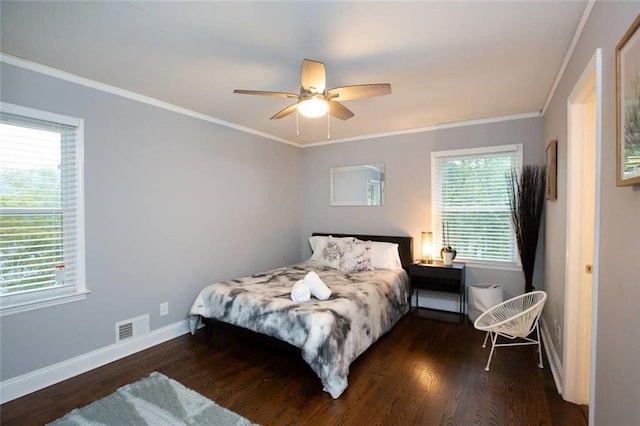 bedroom featuring baseboards, visible vents, wood finished floors, and ornamental molding