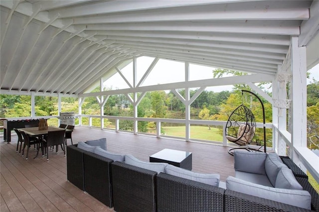 sunroom featuring lofted ceiling with beams