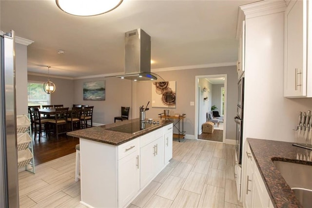 kitchen featuring appliances with stainless steel finishes, island range hood, white cabinets, and crown molding