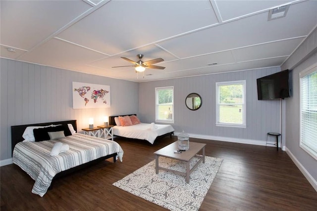 bedroom with ceiling fan, visible vents, baseboards, and wood finished floors