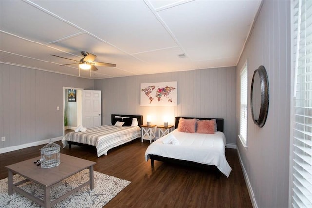 bedroom with ceiling fan, baseboards, and wood finished floors