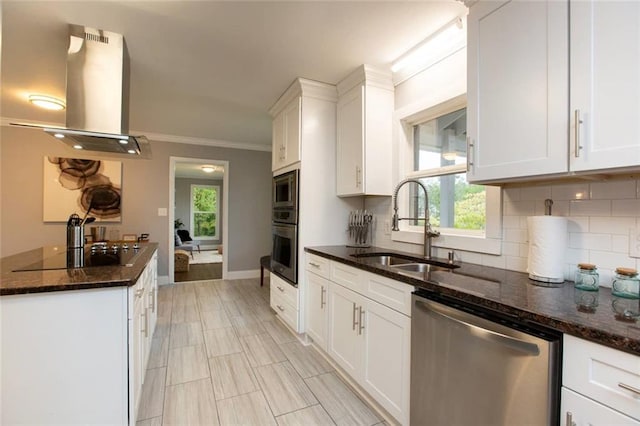 kitchen featuring stainless steel appliances, a sink, white cabinetry, decorative backsplash, and island exhaust hood