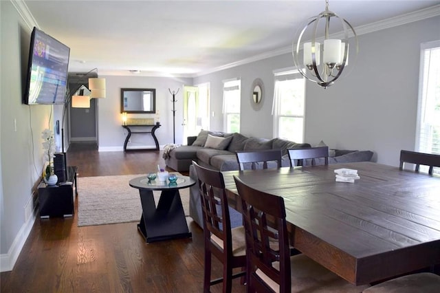 dining area featuring a chandelier, ornamental molding, wood finished floors, and baseboards