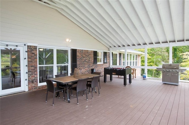 wooden deck featuring outdoor dining space and grilling area