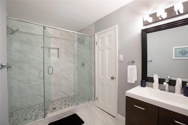 full bath with marble finish floor, a stall shower, and vanity