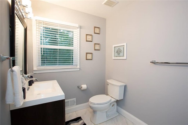 bathroom featuring marble finish floor, vanity, visible vents, and baseboards