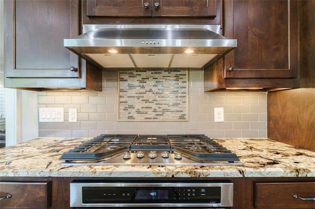 kitchen with tasteful backsplash, extractor fan, oven, and stainless steel gas stovetop