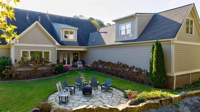 rear view of house with a lawn, a patio area, and a fire pit