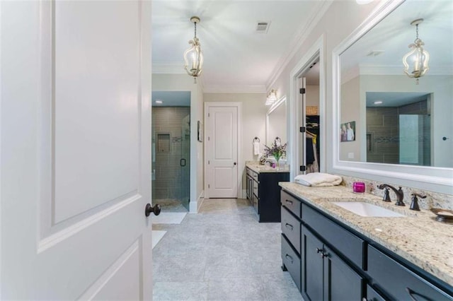 bathroom with ornamental molding, vanity, and a shower with shower door