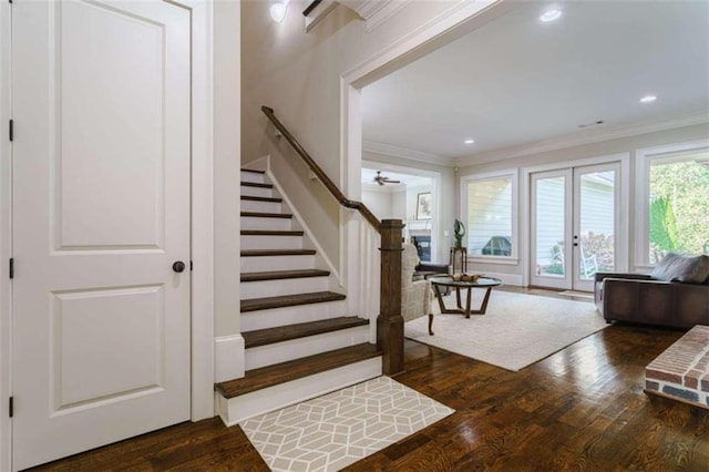 stairway featuring hardwood / wood-style flooring, crown molding, and french doors