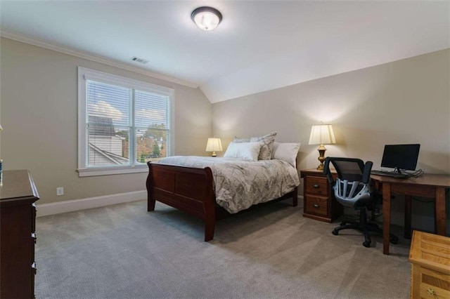 carpeted bedroom with ornamental molding and lofted ceiling