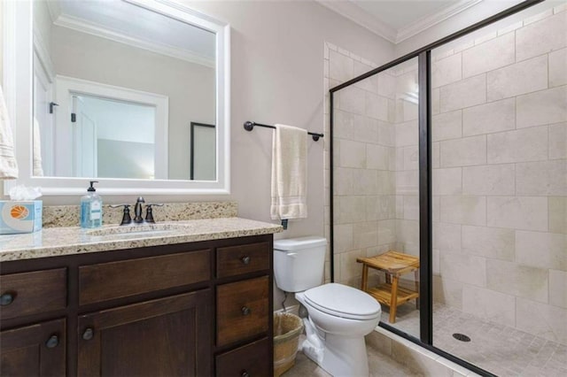 bathroom with a shower with door, ornamental molding, vanity, and toilet