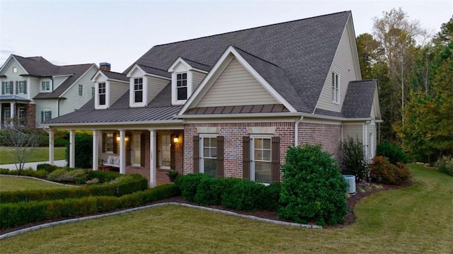 view of front of house with a front yard and covered porch