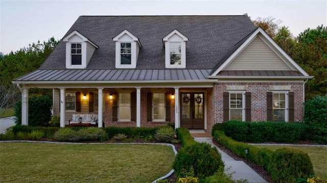 view of front of property with a porch and a front yard