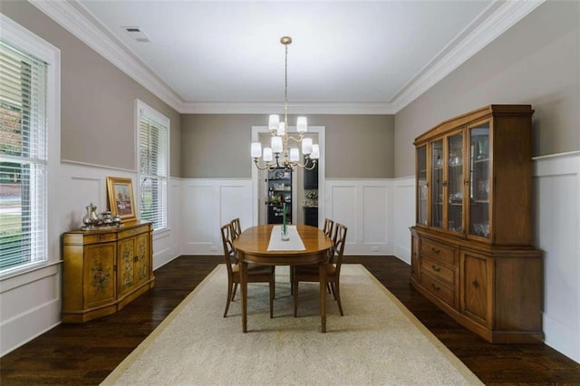 dining space with crown molding, plenty of natural light, and a chandelier