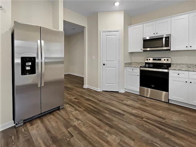 kitchen featuring white cabinets, appliances with stainless steel finishes, and light stone countertops