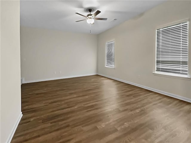 spare room featuring ceiling fan and dark hardwood / wood-style floors