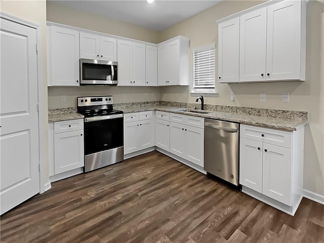 kitchen with sink, stainless steel appliances, and white cabinetry