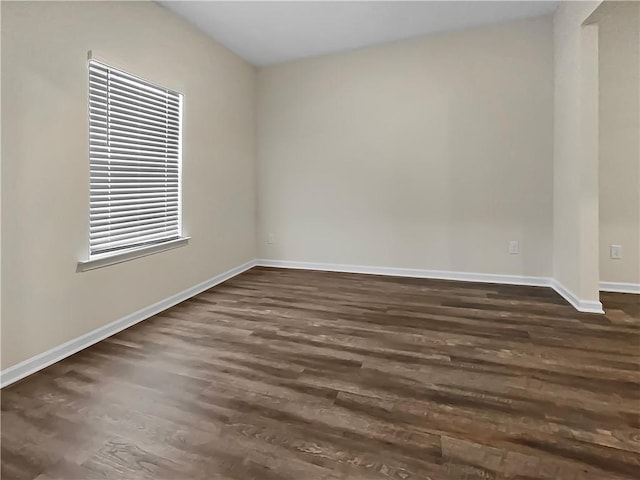 unfurnished room featuring dark hardwood / wood-style floors