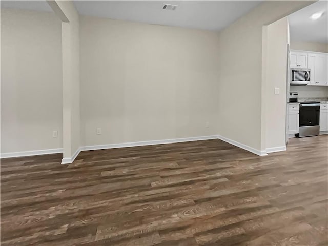 unfurnished room featuring dark hardwood / wood-style floors