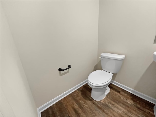 bathroom with toilet and hardwood / wood-style flooring