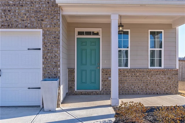 doorway to property with a porch and a garage