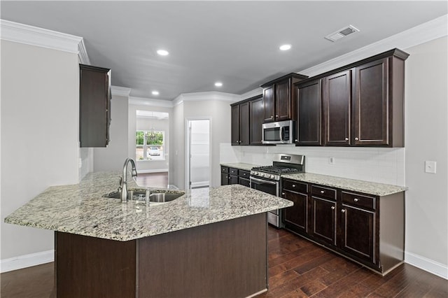350 Paces Dr, Lithia Springs, GA 30122 - kitchen featuring stainless steel appliances, a sink, crown molding, dark brown cabinetry, and decorative backsplash