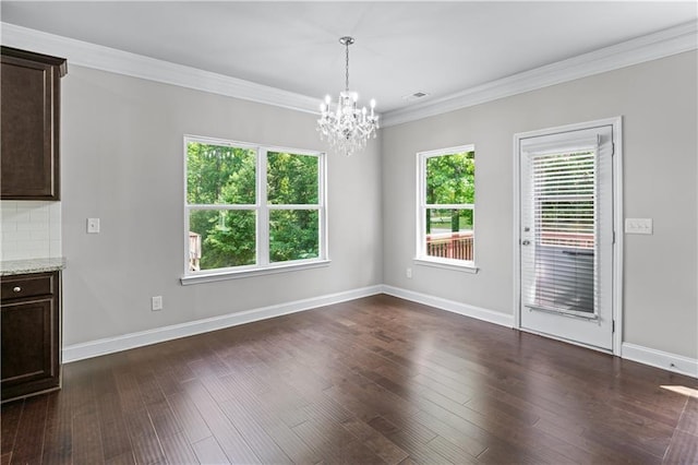 350 Paces Dr, Lithia Springs, GA 30122 - unfurnished dining area featuring a chandelier, ornamental molding, dark wood-type flooring, and baseboards